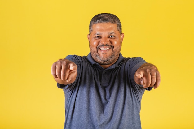 Brazilian black man adult smiling pointing at camera choosing you