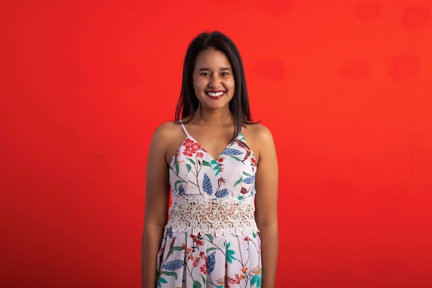 Brazilian brunette woman in flower print dress in studio