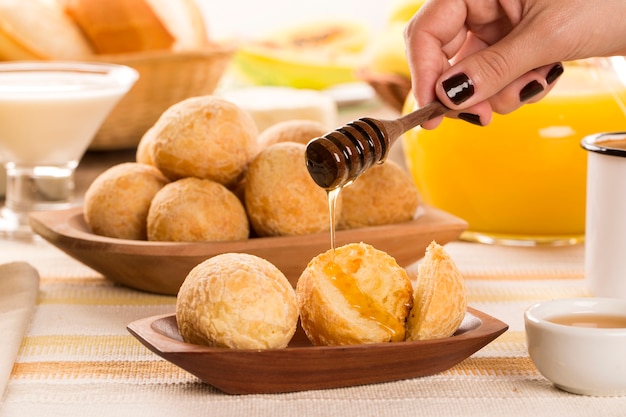 Brazilian cheese buns . Table cafe in the morning with cheese bread and fruits.