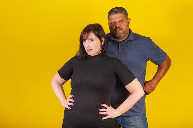 Brazilian couple Caucasian woman and black man hugging hands on hips