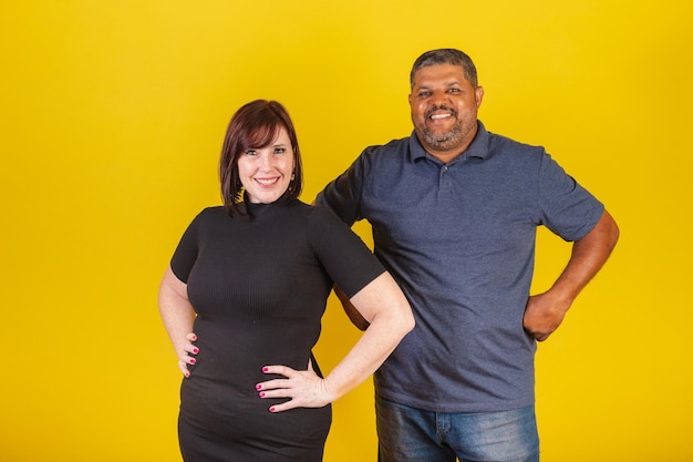 Brazilian couple Caucasian woman and black man hugging hands on hips