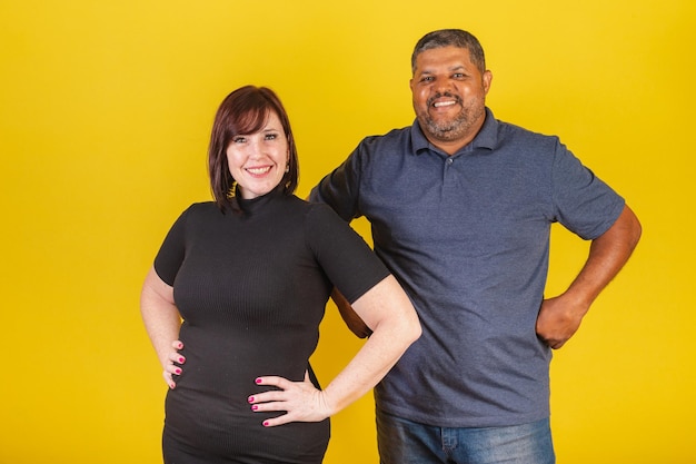 Brazilian couple Caucasian woman and black man hugging hands on hips