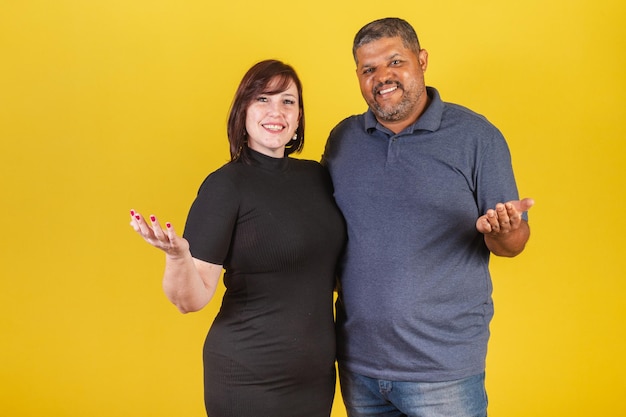 Brazilian couple Caucasian woman and black man with open arms welcome