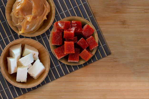 Brazilian desserts Dulce de leche guava and white cheese on wooden table