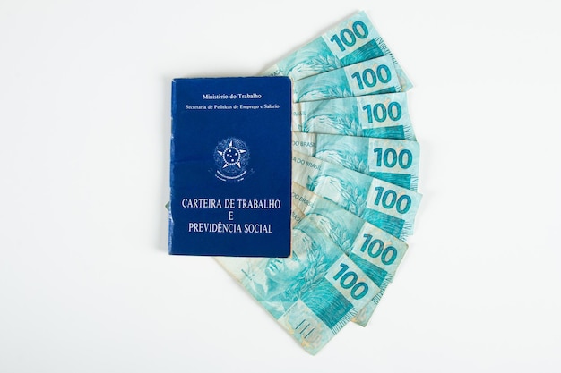 Brazilian document work and social security Carteira de Trabalho e Previdencia Social with Brazilian money banknotes