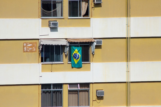 Brazilian flag in the window of a building in the Leblon neighborhood in Rio de Janeiro Brazil