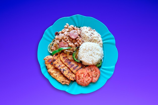 Brazilian food dish with rice beans and chicken