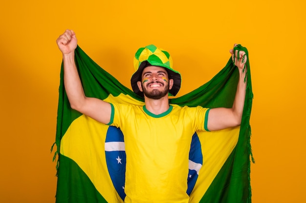 Brazilian football fan emotions celebrating excited happy Supporter of Brazil national soccer team is cheering