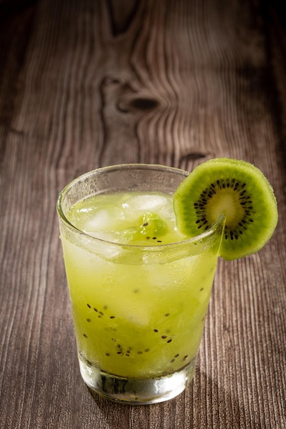 Brazilian Kiwi Caipirinha Cachaca drink with kiwi on wooden background