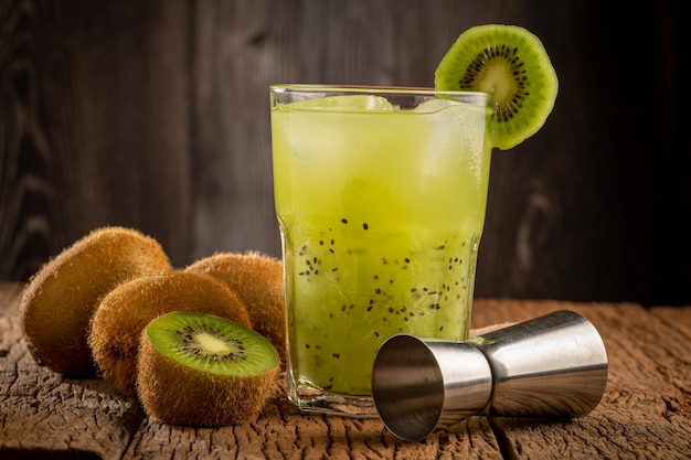 Brazilian Kiwi Caipirinha Cachaca drink with kiwi on wooden background