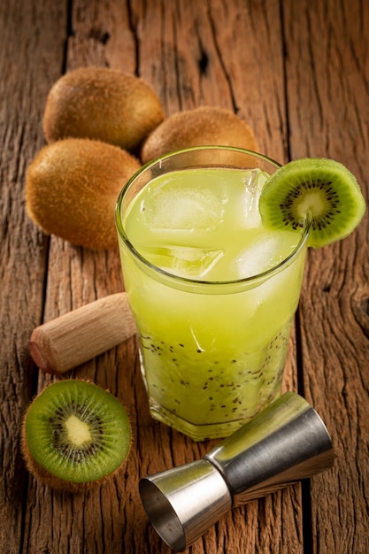 Brazilian Kiwi Caipirinha Cachaca drink with kiwi on wooden background