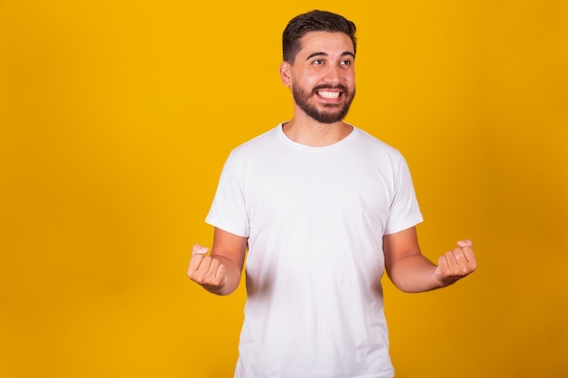 Brazilian Latin American man with arms celebrating happy winning winner happiness joy winner confident