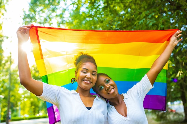 Brazilian lesbian couple in white dress spending time together celebrating engagement in summer park outdoor