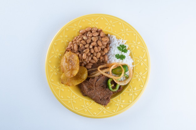 Brazilian lunch food dish with white surface.