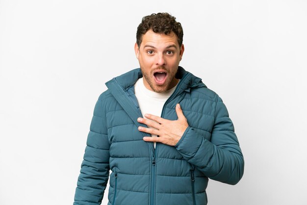 Brazilian man over isolated white background surprised and shocked while looking right