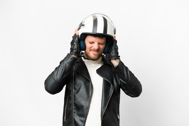 Brazilian man with a motorcycle helmet over isolated white background frustrated and covering ears