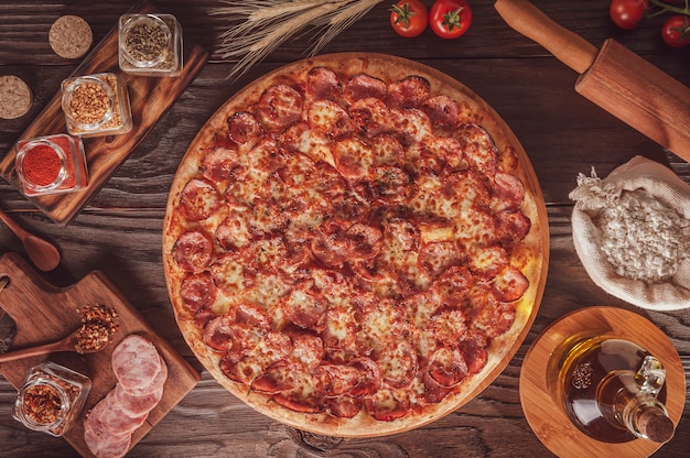 Brazilian pizza with mozzarella, calabrese sausage and oregano (Pizza de calabresa) - Top view.