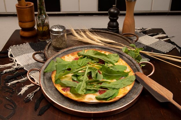 Brazilian pizza with sundried tomatoes arugula and mozzarella