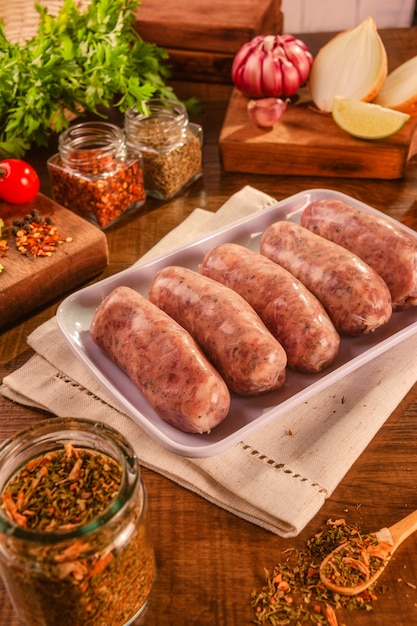 Brazilian pork sausage with chimichurri on white plate with spices and ingredients