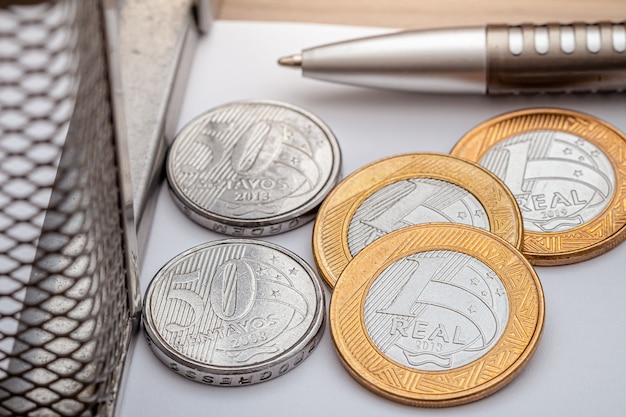 Brazilian real brl coins on white paper in closeup