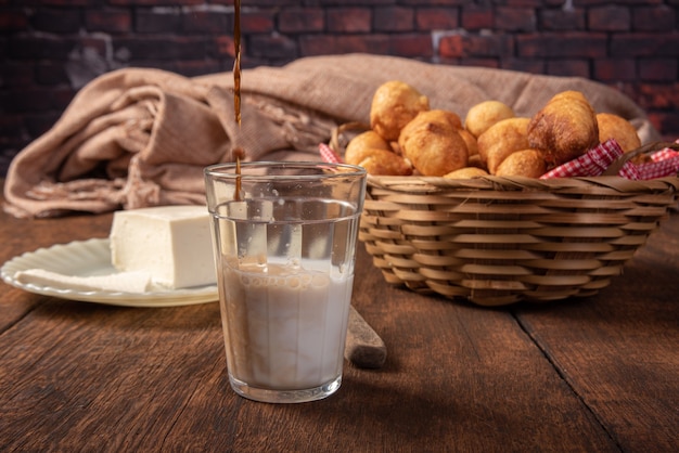 Brazilian sweet called bolinho de Chuva, in a basket, cheese  rustic wood, selective focus.