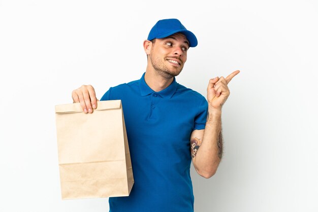 Brazilian taking a bag of takeaway food isolated on white background intending to realizes the solution while lifting a finger up