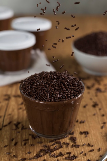 Brazillian chocolate sweet called Brigadeiro in pot on wooden desk background Vegan version