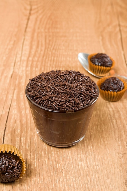 Brazillian chocolate sweet called Brigadeiro in pot on wooden desk background Vegan version