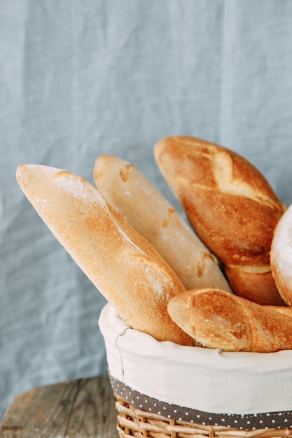 Bread assortment of French baguette and rye bread. Bread basket close-up.