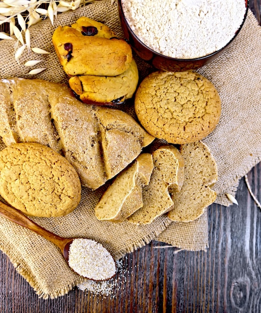 Bread and biscuits oat flour on dark board top