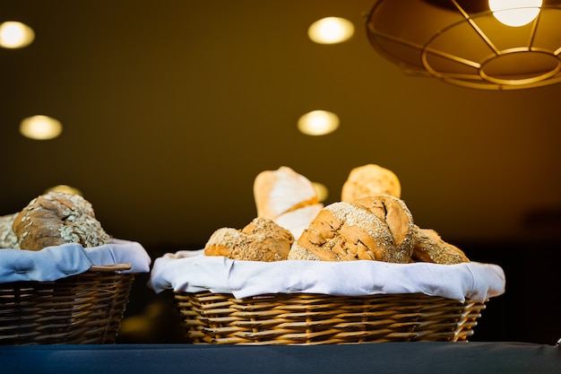 Bread and buns inside wicker basket