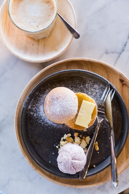 Bread and butter topping with icing sugar served with a scoop of taro ice cream.