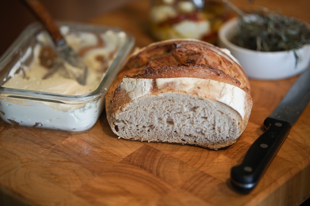 Bread and cream cheese in glass container for breakfast