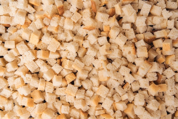 Bread cut into square slices for baking in the oven top view The process of making crackers