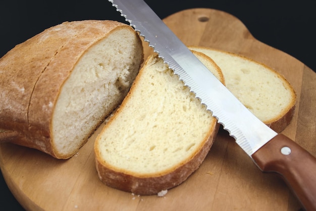 Bread Knife Slicing Through a Loaf Cut fresh bread with a knife