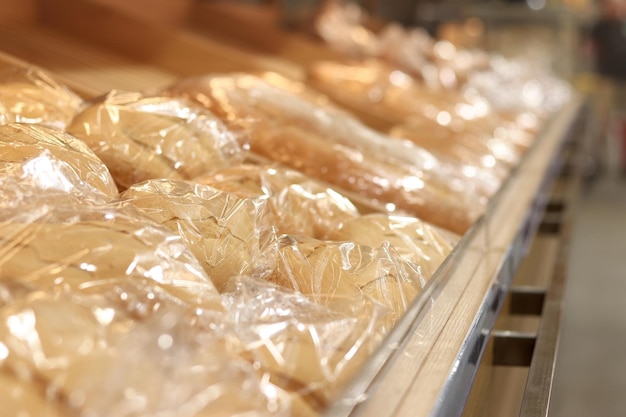 Bread in a package in a store on a shelf Baton closeup Bread in the supermarket