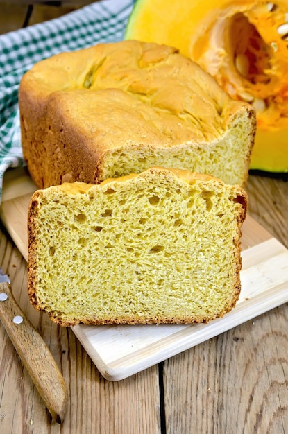 Bread pumpkin on a board with a pumpkin