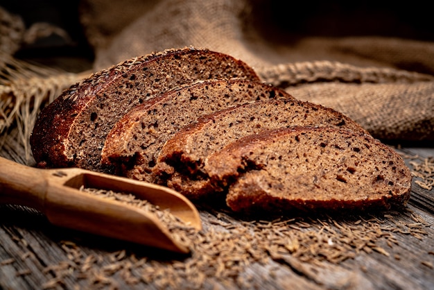 Bread rye spikelets. Freshly baked traditional bread on wooden table. Healthy food