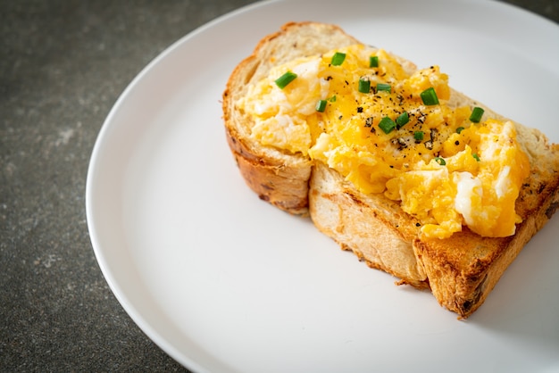 bread toast with scramble egg on white plate