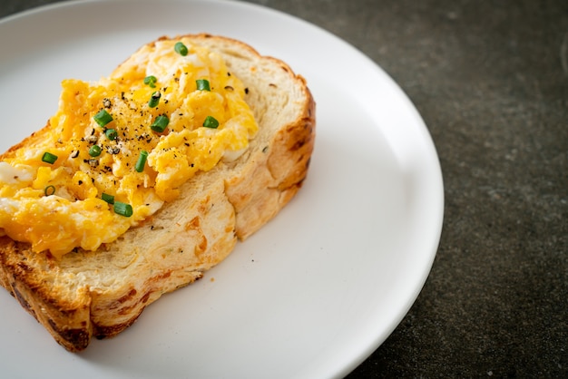 bread toast with scramble egg on white plate