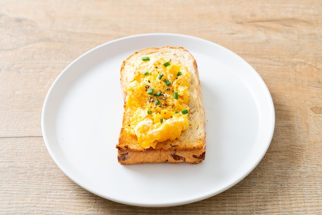 bread toast with scramble egg on white plate