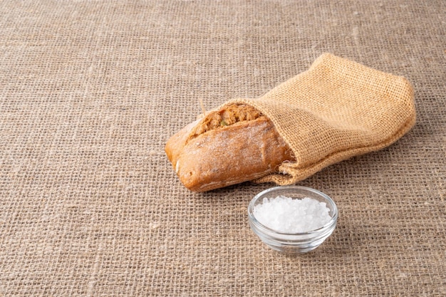 Bread traditional sourdough bread on a background of burlap The concept of traditional ways of ba