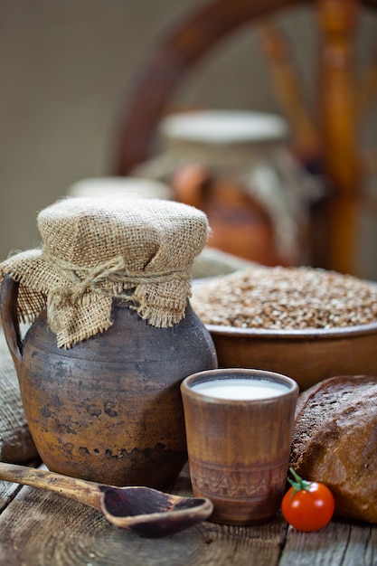 Bread and wheat grains on a wooden background