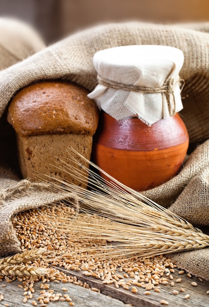 Bread and wheat on a wooden board