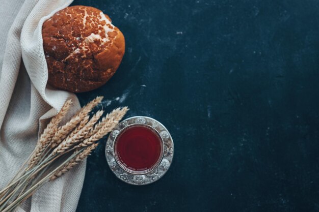 Bread wine and ears of wheat on a dark background communion concept