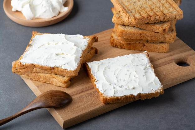 Bread with cottage cheese on a grey table