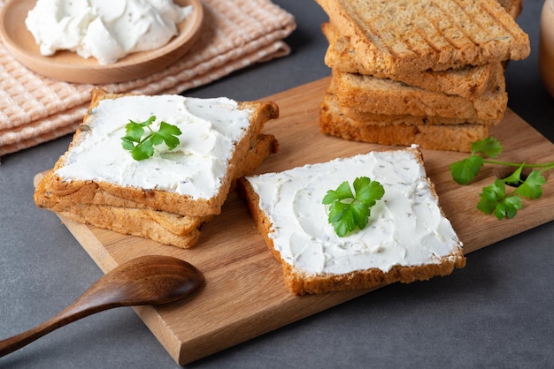 Bread with cream cheese on grey table Whole grain bread with seeds