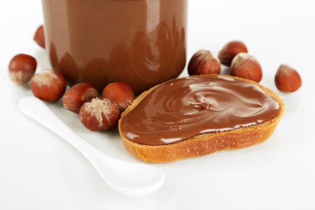 Bread with sweet chocolate hazelnut spread isolated on white