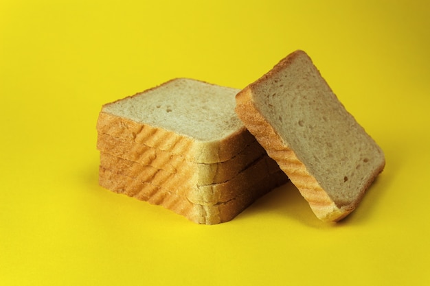 Bread on a yellow background close-up side view