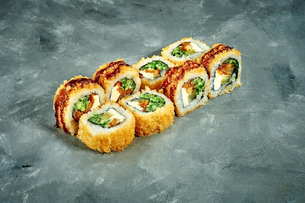 Breaded sushi roll with eel cucumber on a gray background Selective Focus Sushi Menu